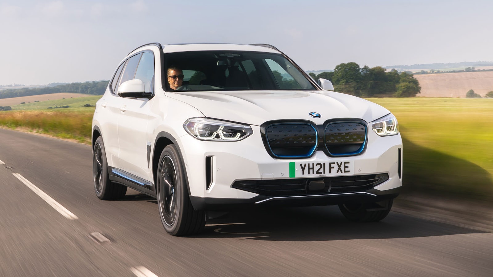 White BMW iX3 on road