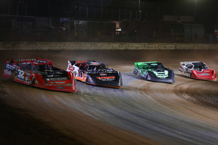 Four dirt track racers competing