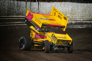 Yellow sprint car racing on dirt