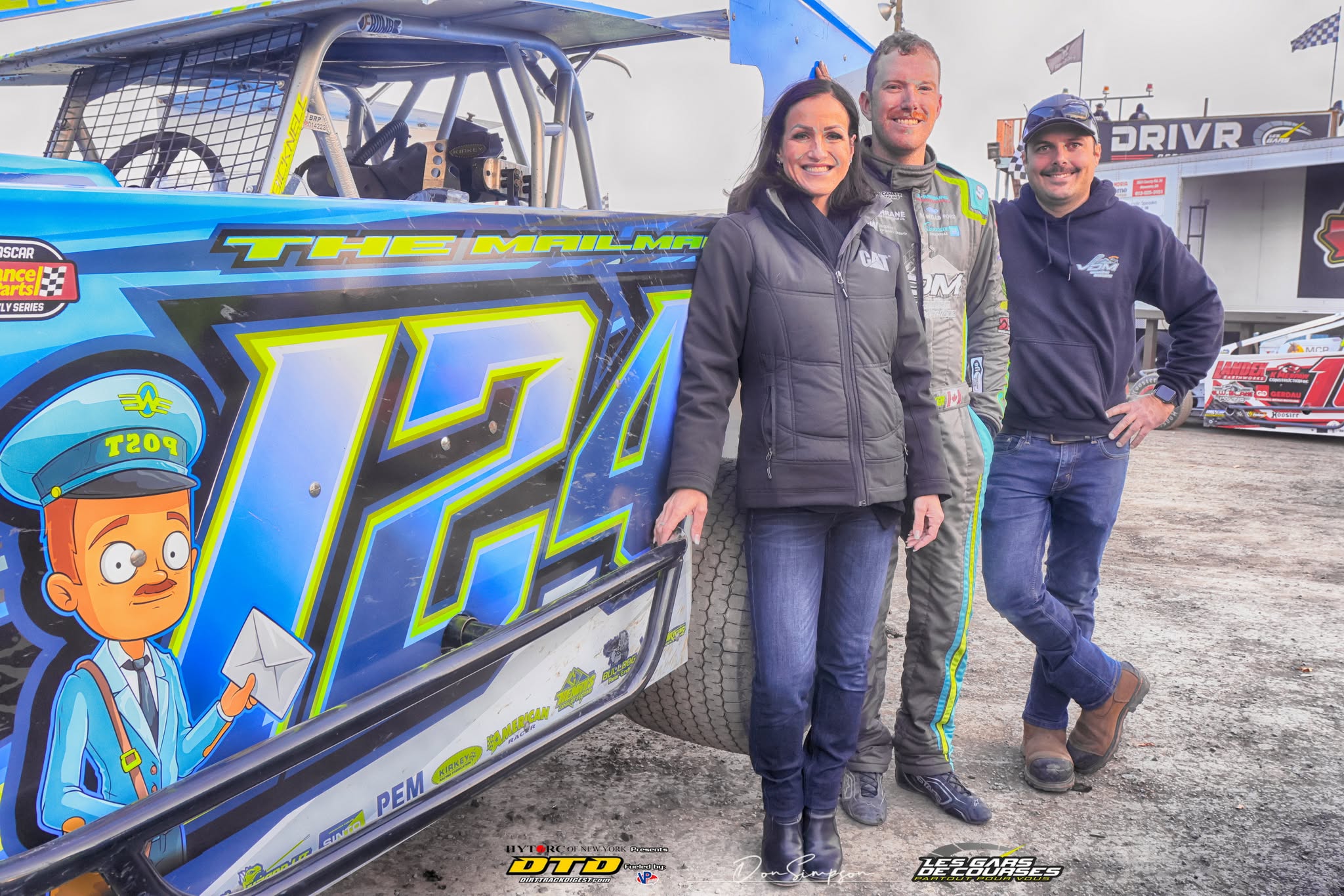 Three racers in dirt track car