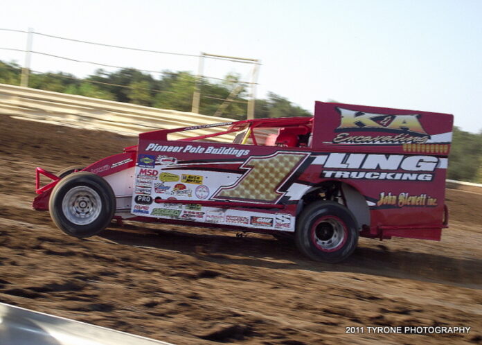 Race car speeding on dirt track