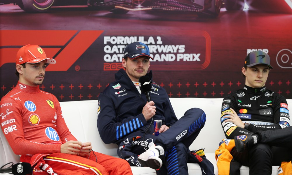 Three F1 drivers on white couch