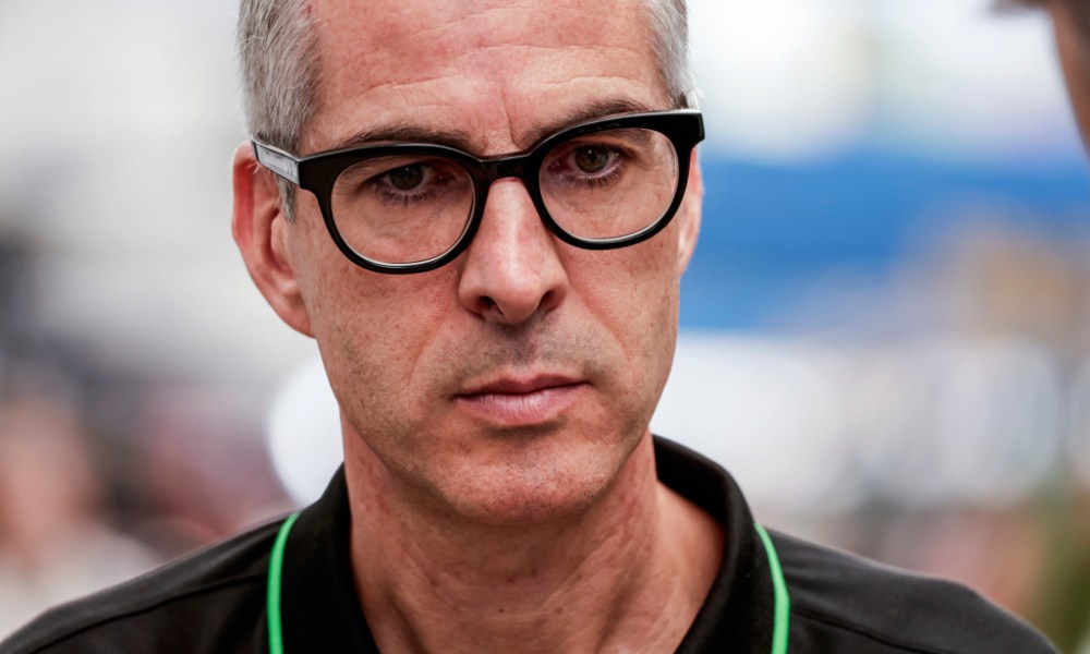 Man wearing glasses in IndyCar paddock