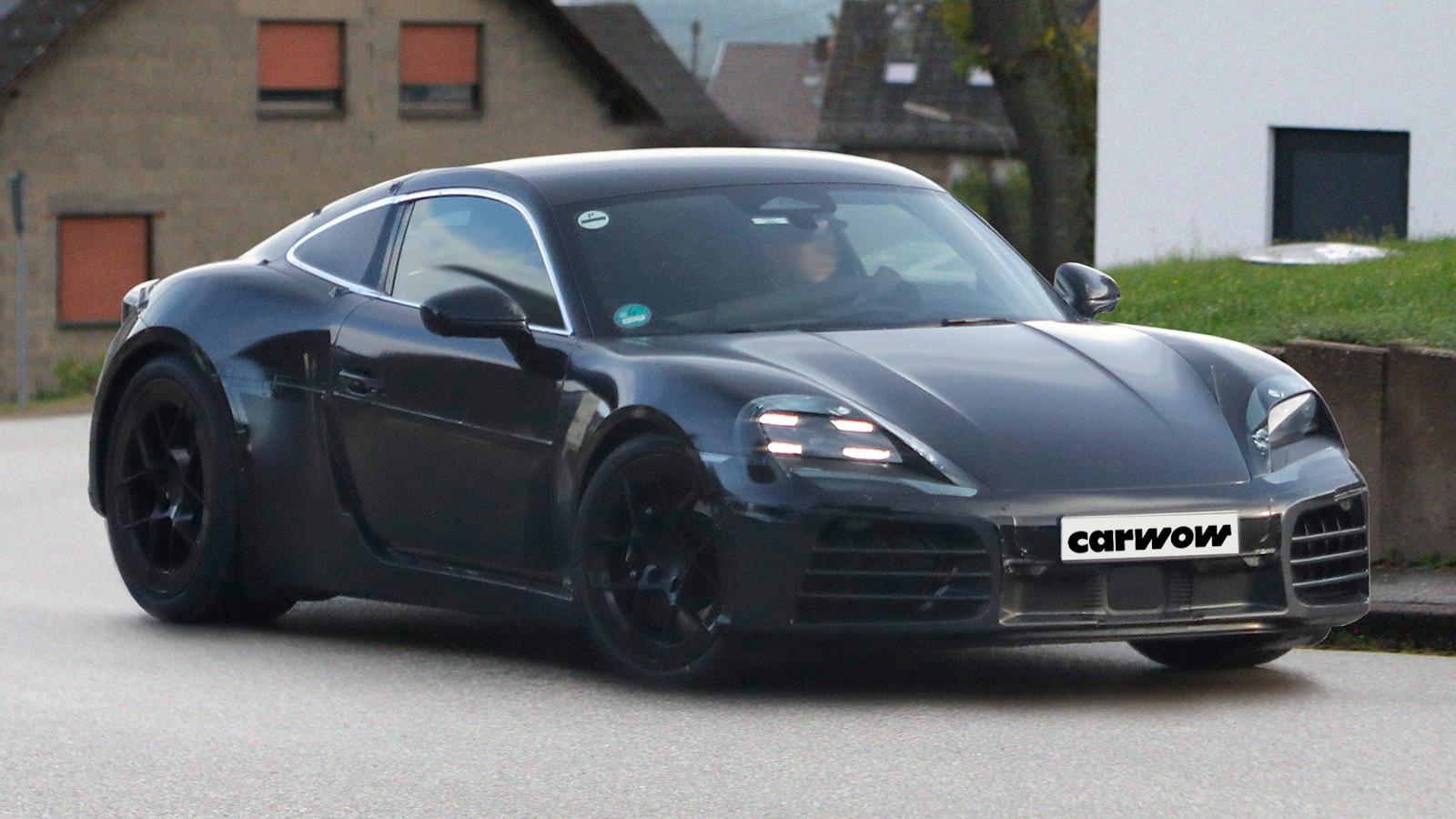 Black Porsche Cayman, front quarter view