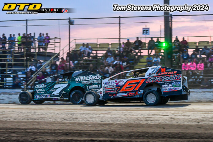 Race cars battling on dirt track