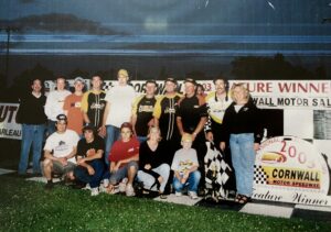 People pose at dirt track race