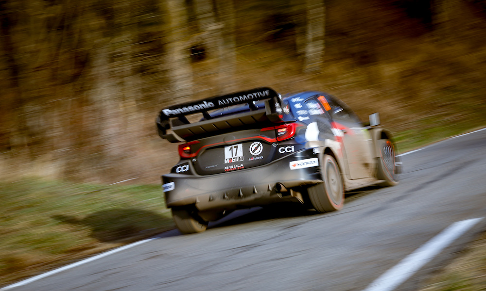 Rally car races through mountain road