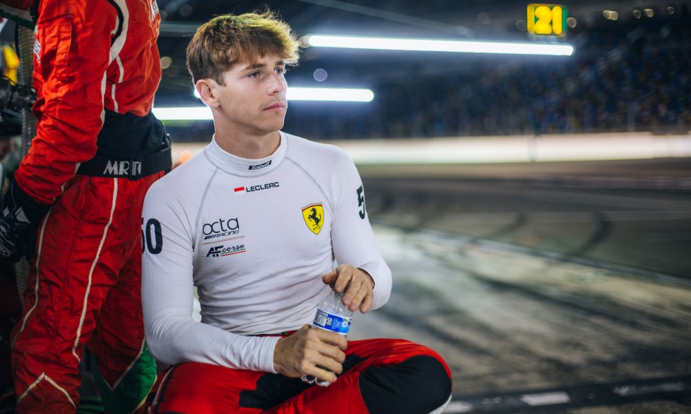 Racing driver drinks from bottle