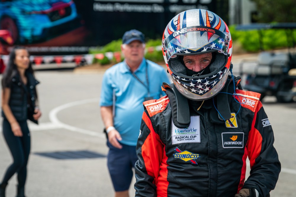 Racecar driver wearing helmet