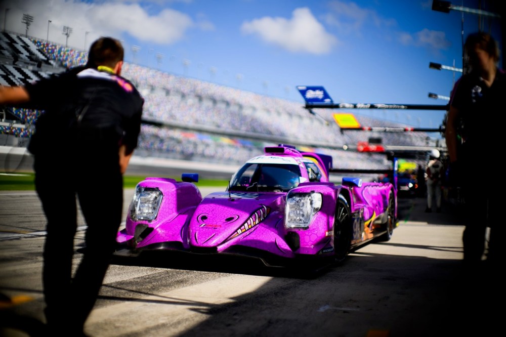 Pink race car with pit crew