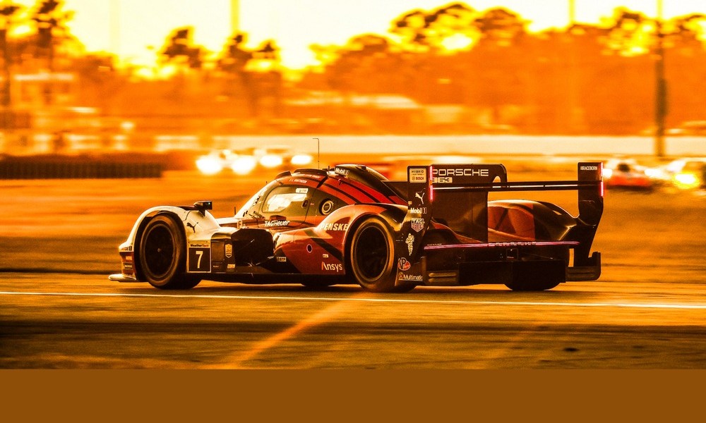 Porsche race car racing at dusk