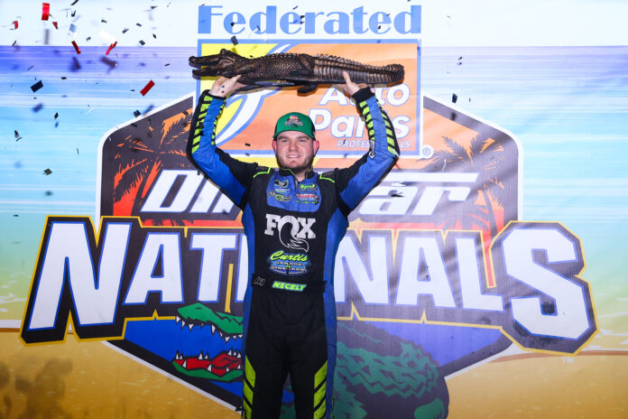 Race winner holds Big Gator trophy