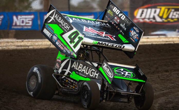 Sprint car racing through dirt turn