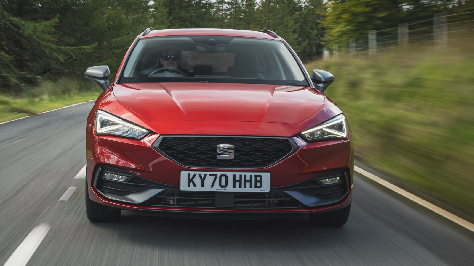 Red Seat Leon on road