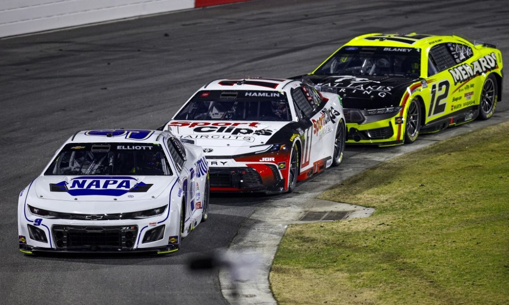 Three IndyCars racing on track