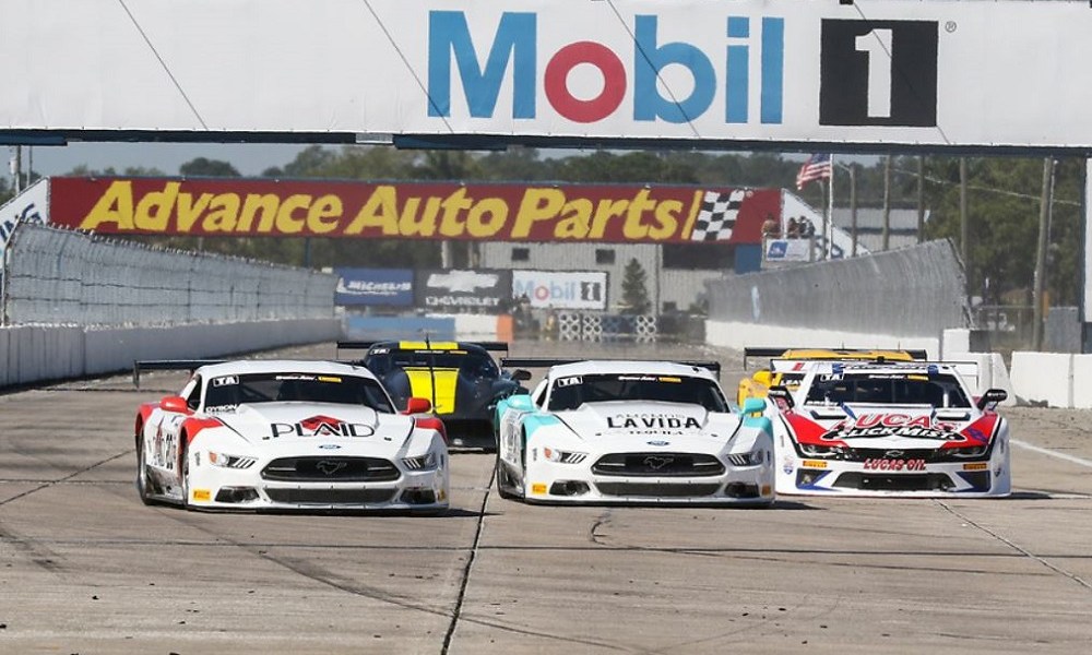 Race cars competing on NASCAR track