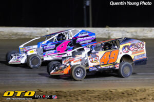 Race cars competing on dirt track