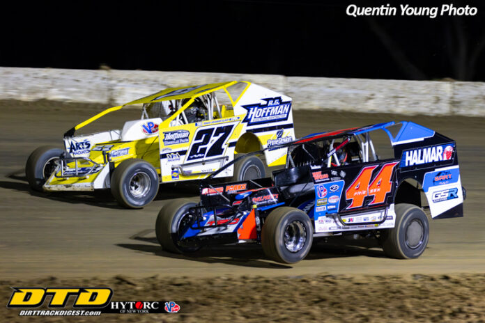 Two dirt track racers competing