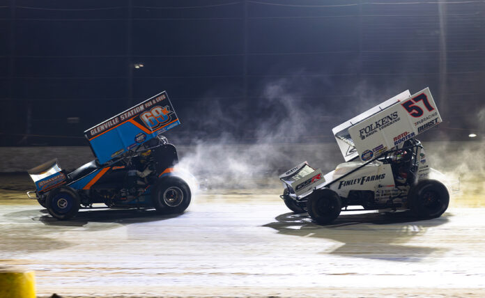 Sprint cars racing on dirt track