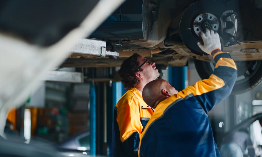 Mechanics checking car's brake system