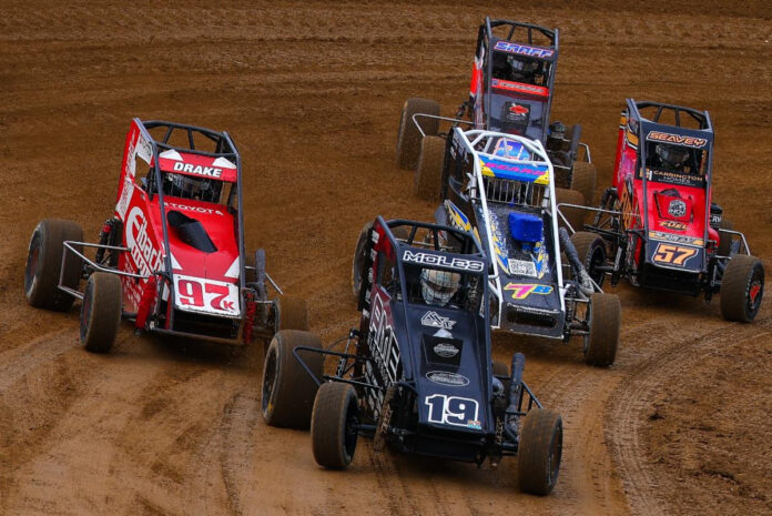 Sprint cars racing on dirt track