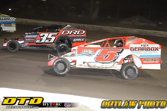 Modified dirt sprint cars racing head-to-head