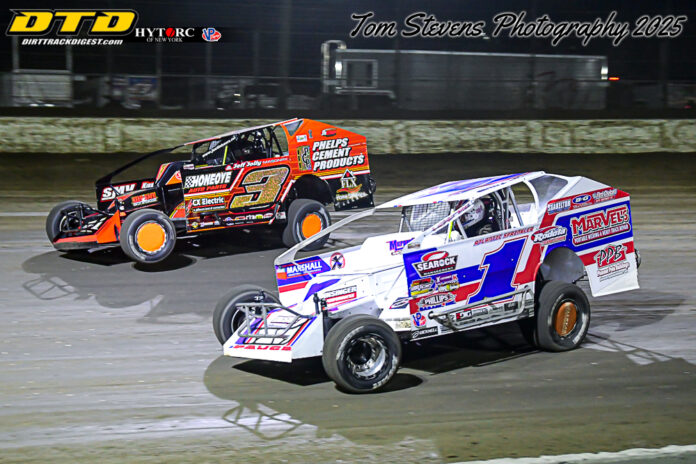 Race cars battle on dirt track