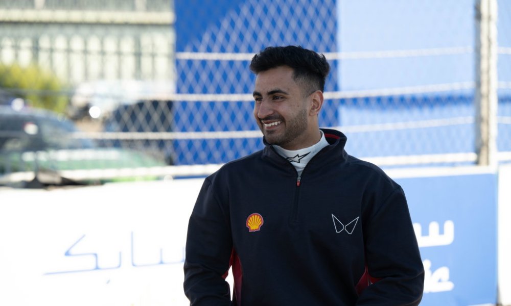 Racing driver smiling in black jacket