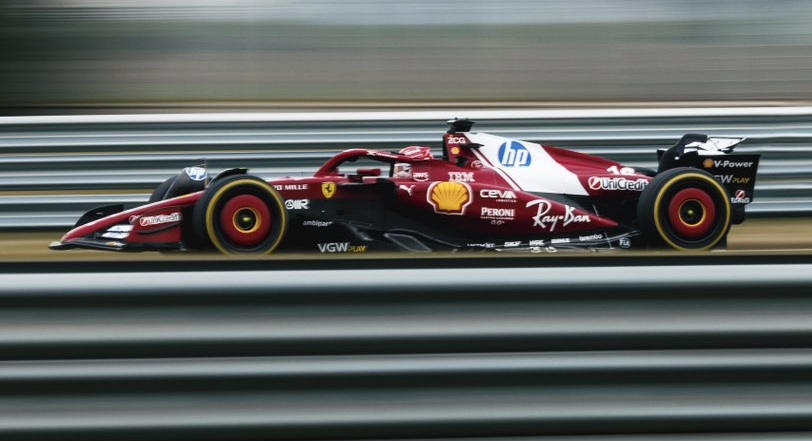 Red racecar speeding on racetrack