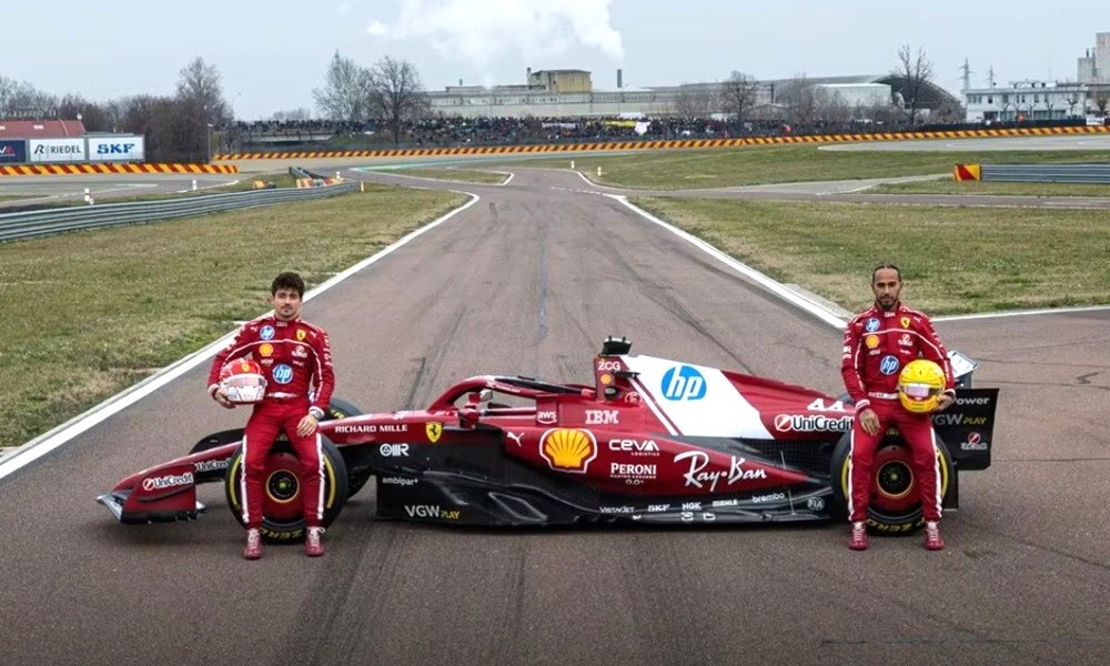 Two racers beside racing car