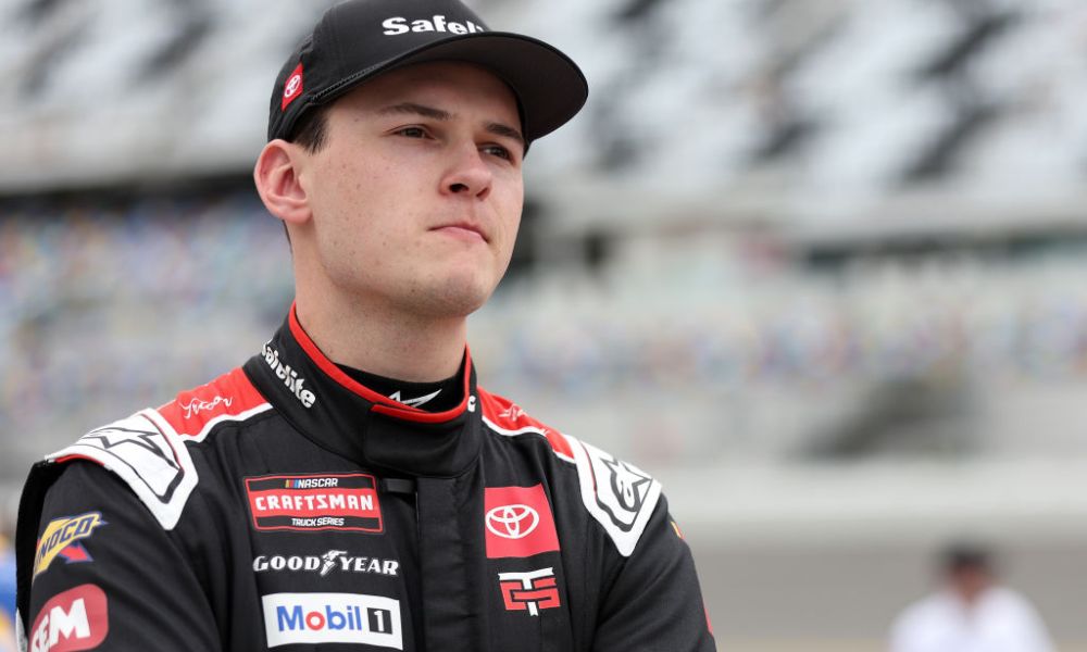 Racing driver wearing black Penske uniform