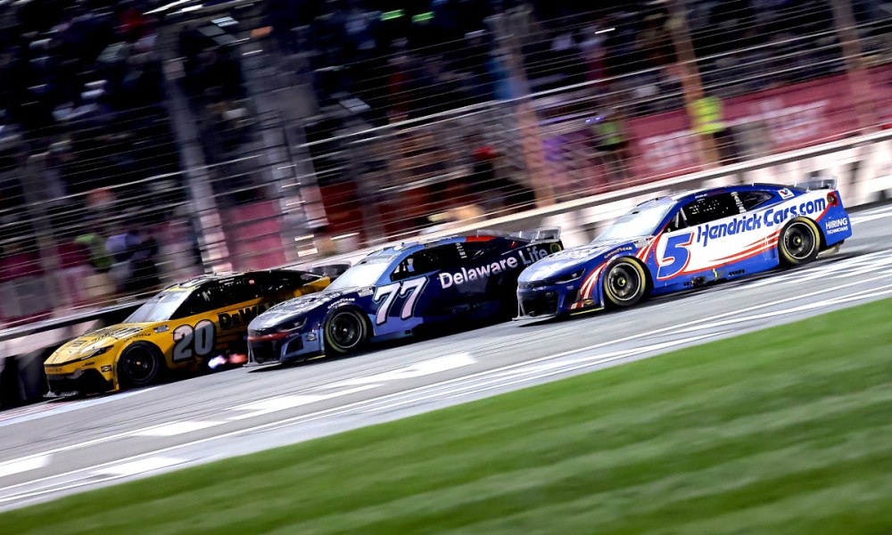 Three IndyCars racing in formation