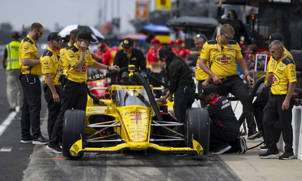 IndyCar pit crew servicing vehicle