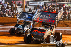 Sprint cars racing on dirt track