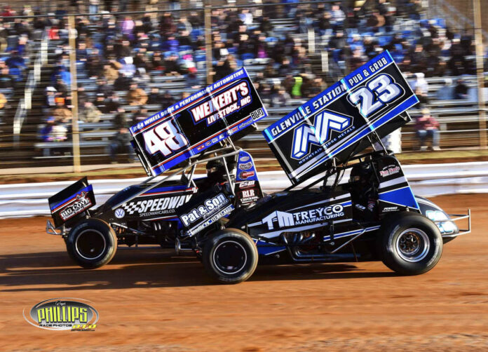 Sprint cars racing on dirt track