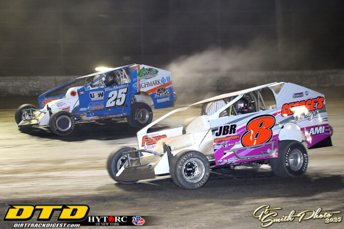 Two dirt track racers competing