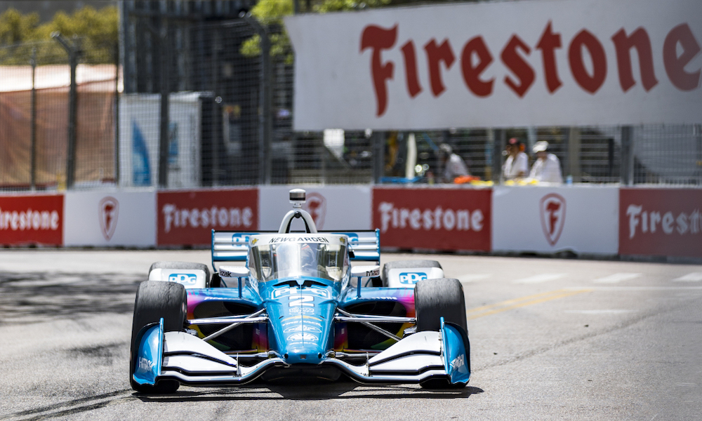 Blue IndyCar on racetrack.