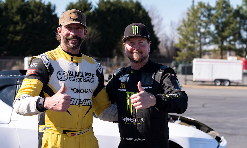 Two racecar drivers standing together