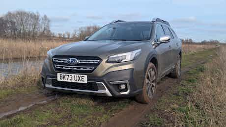 Outback parked on grassy field