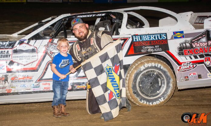 Father and son hold racing flag