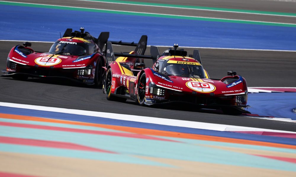 Two Ferrari racers battling on track