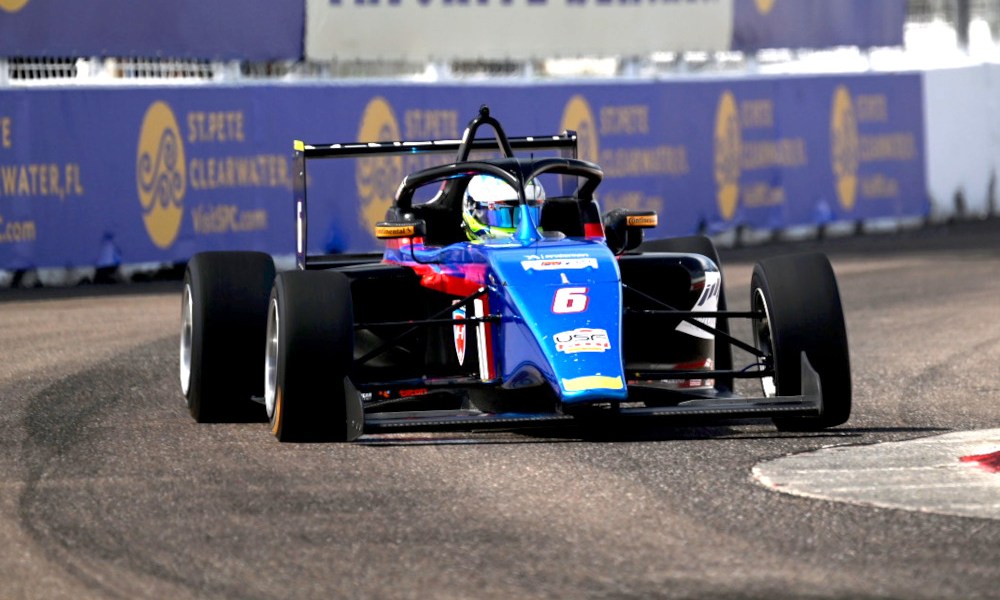 Blue racecar speeding on racing track