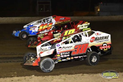 Dirt sprint cars racing at night