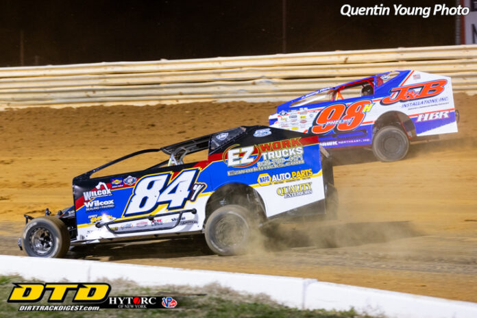 Two sprint cars racing on dirt