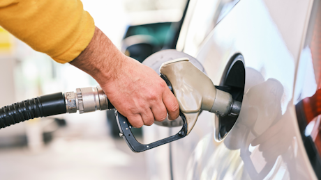 Man putting fuel in car