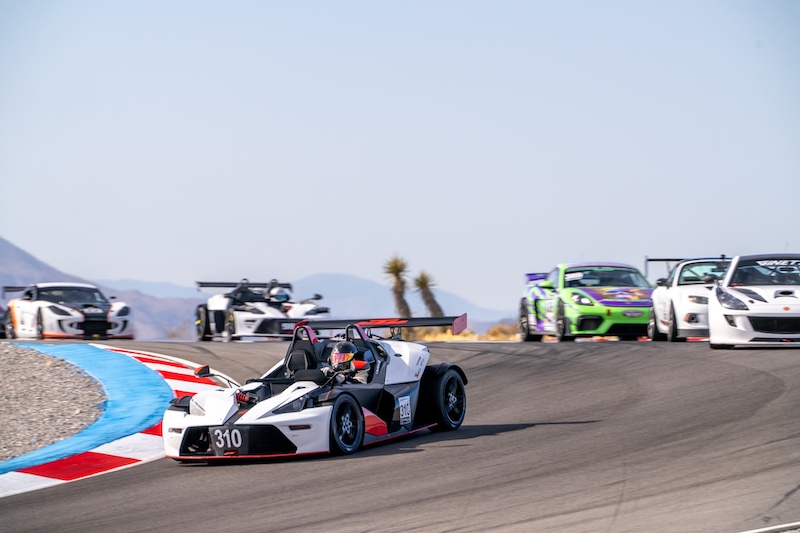 Racing cars competing on speedway track