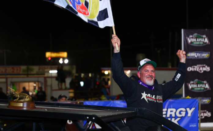 Curt Spalding celebrates victory with flag