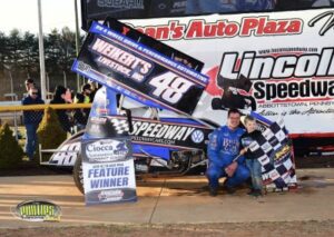 Man beside dirt track race car