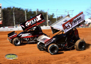 Two dirt track racers competing