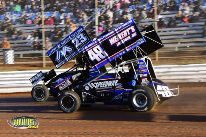 Racing officials gathering at dirt track